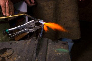 Heating metall by gas burner in forge