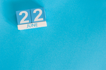 June 22nd. Image of june 22 wooden color calendar on blue background. Summer day. Empty space for text