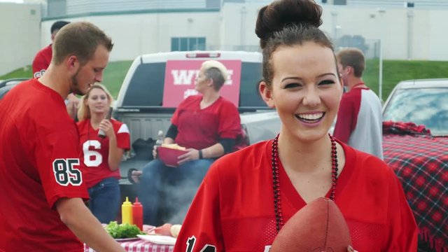 Tailgate: Woman Smiling To Camera Has Friend Come Over To Join Her