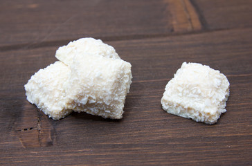 Fototapeta na wymiar Cakes with coconut on dark wood table