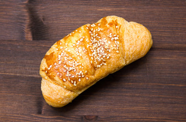 Salted croissant on a wooden table seen from above