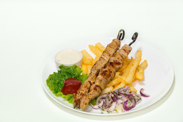Skewer chicken, meat grilled with French fries, ketchup, cacık and onions marinated.Greek cuisine, Shashlik,souvlaki.