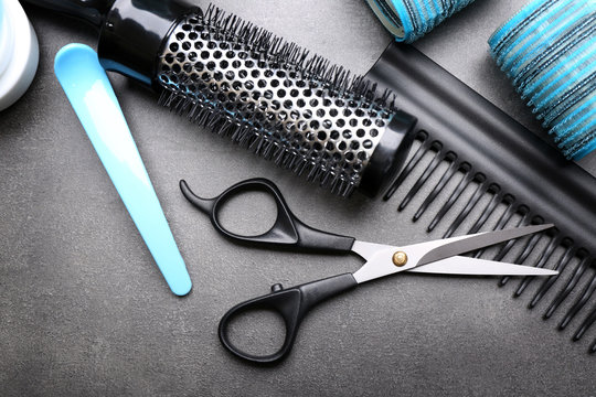 Barber set with tools and cosmetic on grey background