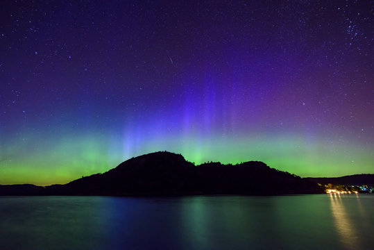 colorful northern lights (Aurora Borealis) at fjord landscape, Norway, Europe
