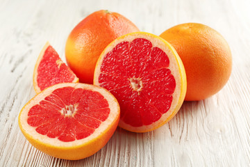 Juicy grapefruits on wooden background