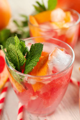 Ripe grapefruits and fresh juice with mint, close up