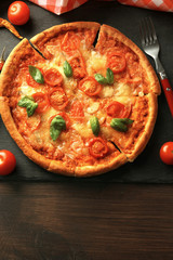 Margherita pizza with tomatoes on slate plate
