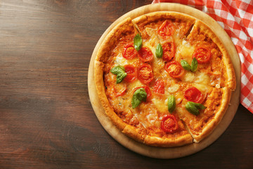 Margherita pizza on wooden table