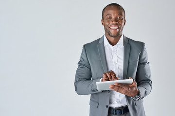 Young black male professional holding tablet device smiling - 106819375