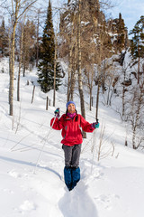 Girl tourist in winter on a background of red rocks, Ural mounta