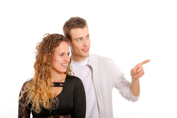 Young couple pointing on white