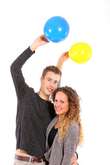 young couple holding balloons on white background 