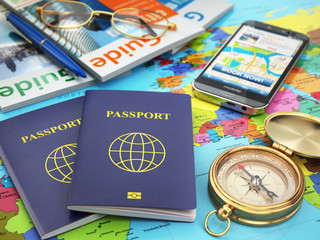 Travel guide concept. Passport, compass, guide books, mobile pho