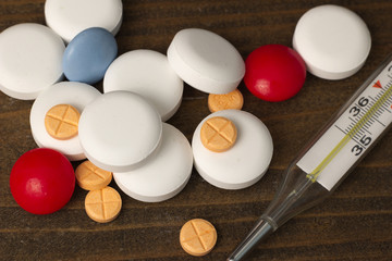 vitamins pills , thermometer macro top view
