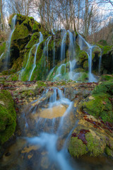 Fototapeta premium Beautiful waterfalls and mountain stream in Transylvania, in early spring