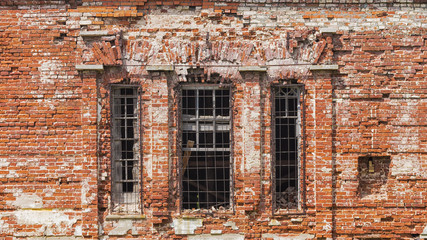 The facade of the old building of red brick