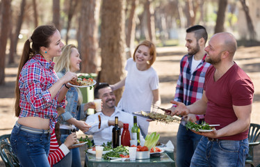 Friends taking pictures together at barbecue