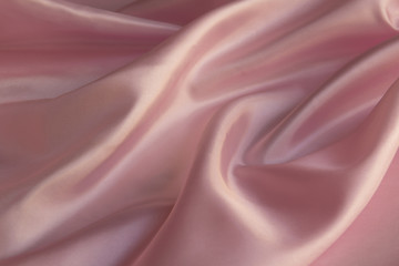 Shiny Pink silky fabric folds background texture