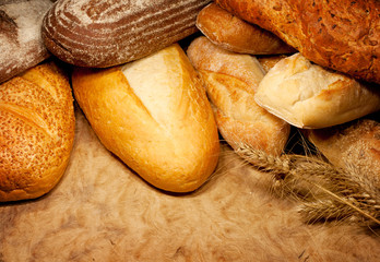 assortment of baked bread with wheat