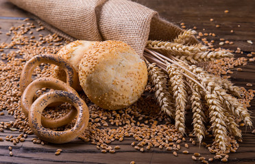 Assortment of baked bread on wooden table background