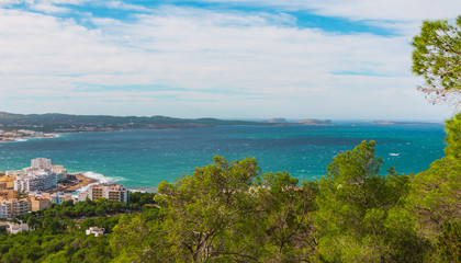 Panoramic hill side view from St Antoni de Portmany, Ibiza, into balearic sea on a clearing day in November, featuring the oft viewed Conejera islands.