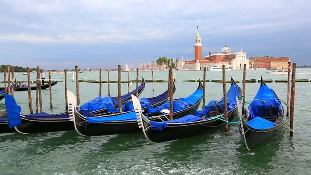 Parked blue gondolas in sunny day, province of Venice, Italy 