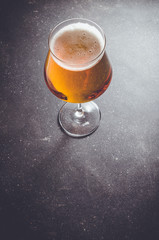 Beer glass on dark table. Close up