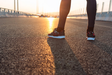 feet of an athlete running on a park pathway training for fitnes