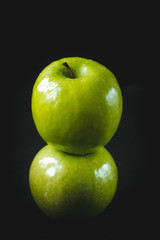 fresh green apple on black background