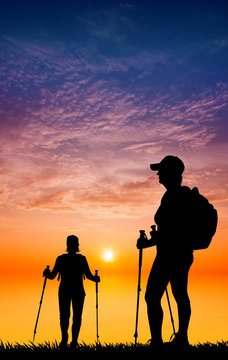 Nordic walking silhouette at sunset