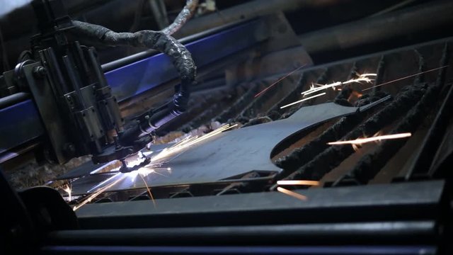 industrial machine, laser cutting through metal sheet