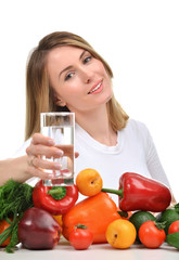 Woman with glass of pure drinking water and green vegetables and