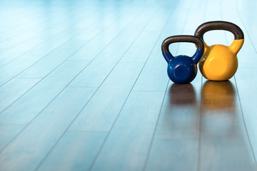 exercise weights - iron dumbbell with extra plates on a wooden d