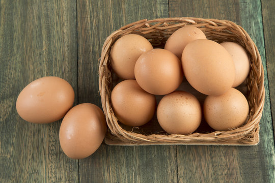 Eggs in a basket on wooden background