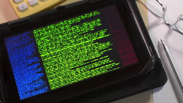 Digital tablet undergoing a cyber attack and data base hack on a computer system. Internet cyber crime and data loss.