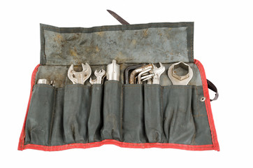 Old tool roll carried on an antique motorcycle for many miles. From back in the days when you could make your own repairs on the road.