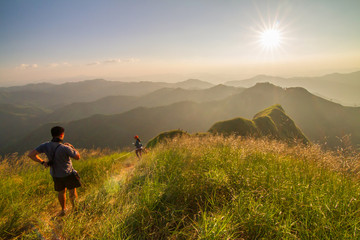Unidentified Tourism walking on high mountain with sunlight