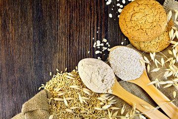 Flour and bran oat in spoon with grains on board