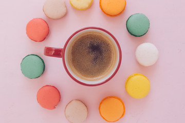 A cup of morning americano coffee with colorfull french macarons