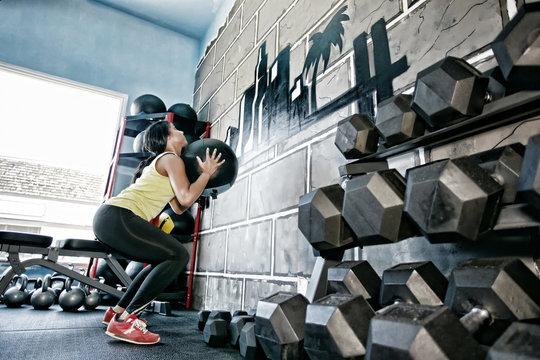 Hispanic woman exercising in gym