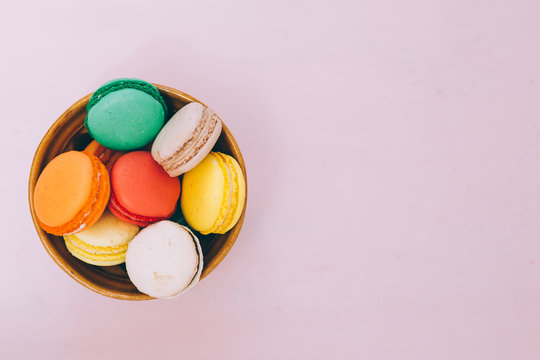 Colorful france macarons on pink background
