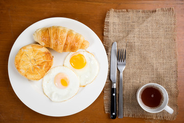 breakfast biscuit croissant egg coffee