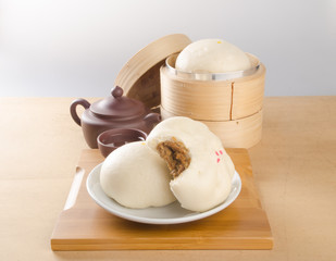pao or dim sum with chinese tea on background.