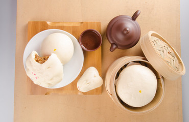 pao or dim sum with chinese tea on background.