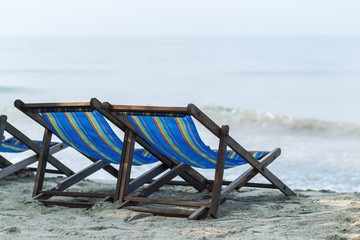 Old vintage wooden sun beds at the beach
