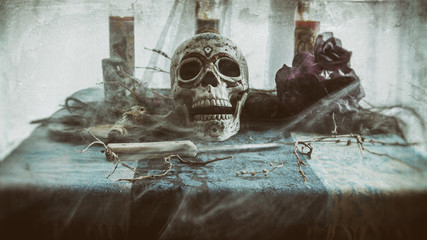 Voodoo Mist Skull Ritual. Voodoo related objects on a table including a skull, a knife and candles. Smoke or mist. - obrazy, fototapety, plakaty