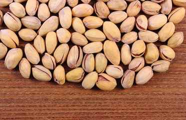 Pistachio nuts on wooden table, healthy eating