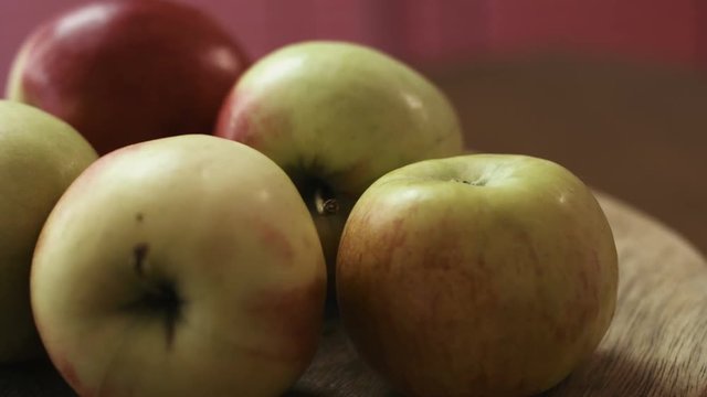 Close up of fresh delicious red and green apples on a table, wooden background.