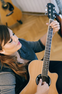 Woman Recording Guitars and at his Home Sound Studio.