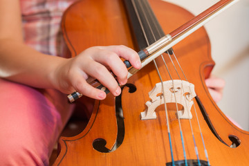 Cello instrument close up view, young musician playing